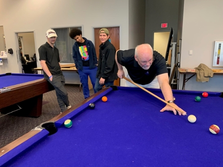 People playing pool at AITS game night. 